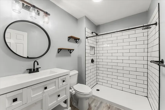 a bathroom with a sink toilet and shower