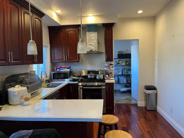 a kitchen with a sink a stove and a refrigerator