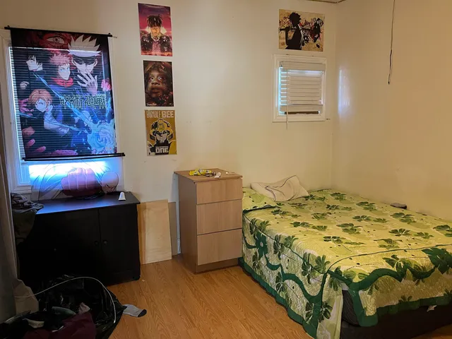 a bedroom with a bed and a wall painting