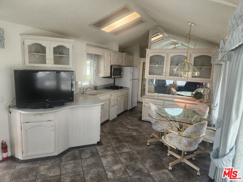 84136 Ave 44, Unit 306 Indio, CA 92203 - Photo 7 of 13 a living room with furniture and a flat screen tv