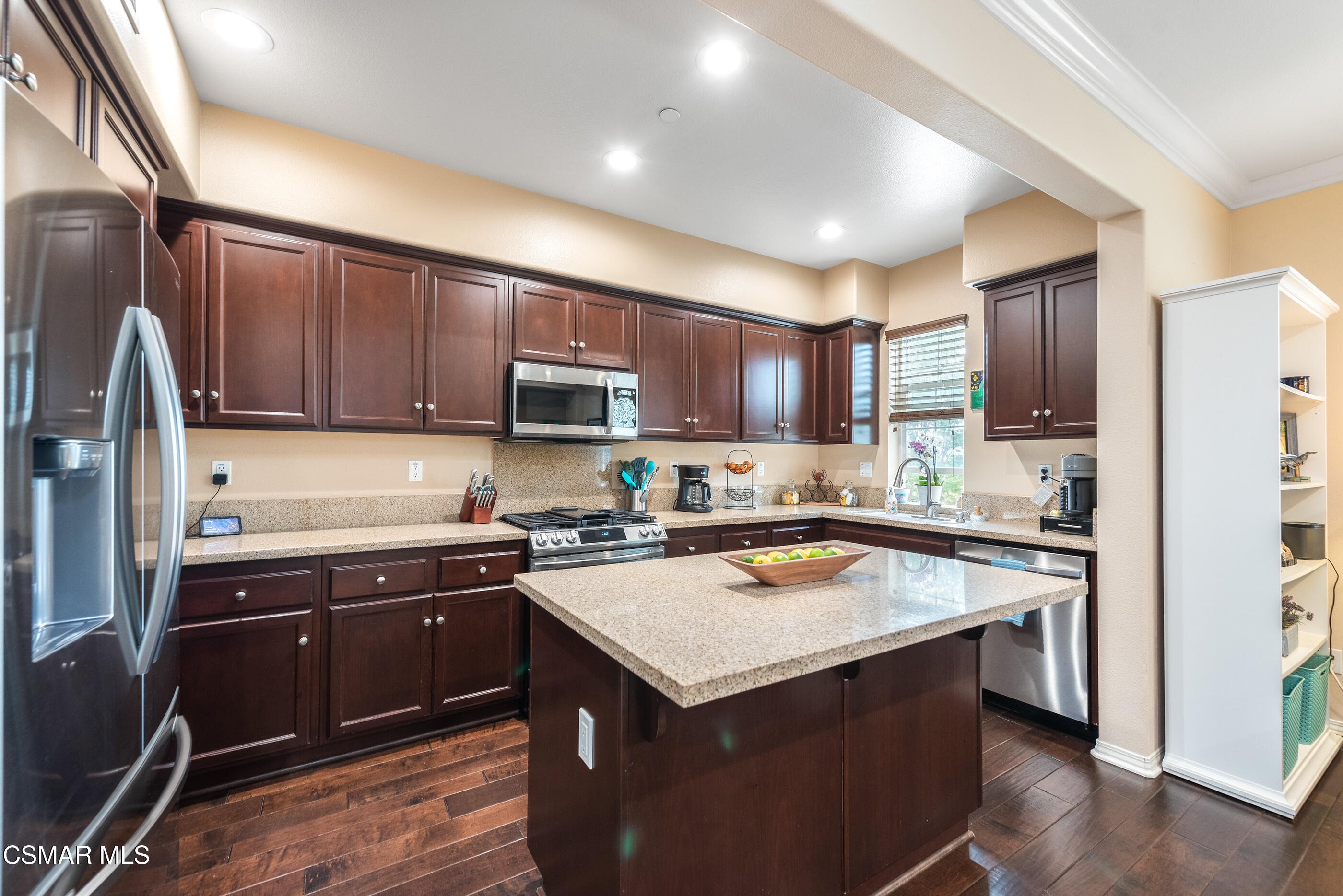 3116 North Oxnard Boulevard Oxnard, CA 93036 - Photo 16 of 46 a kitchen with a sink a stove a refrigerator cabinets and a counter top space