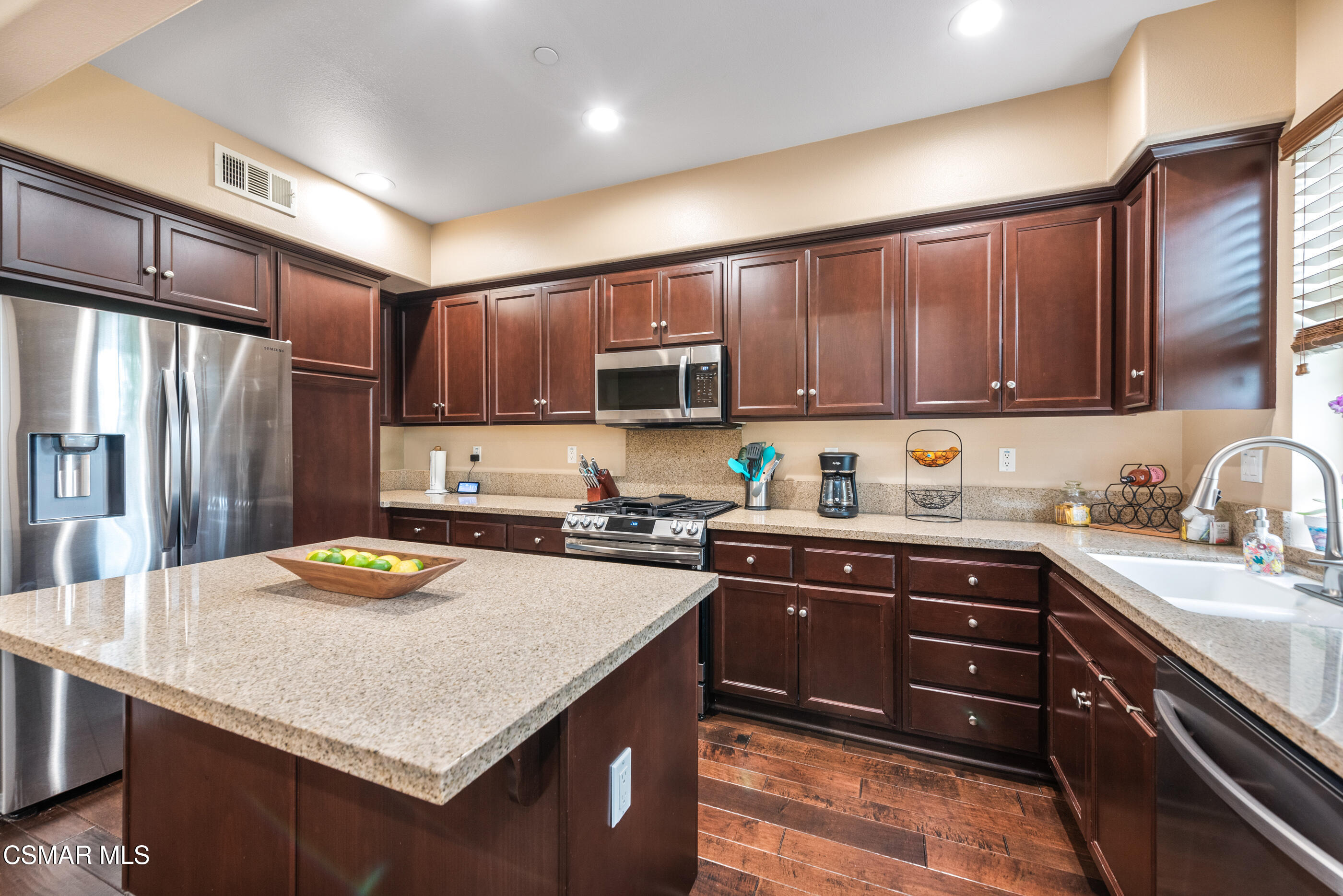 3116 North Oxnard Boulevard Oxnard, CA 93036 - Photo 17 of 46 a kitchen with granite countertop stainless steel appliances and wooden cabinets