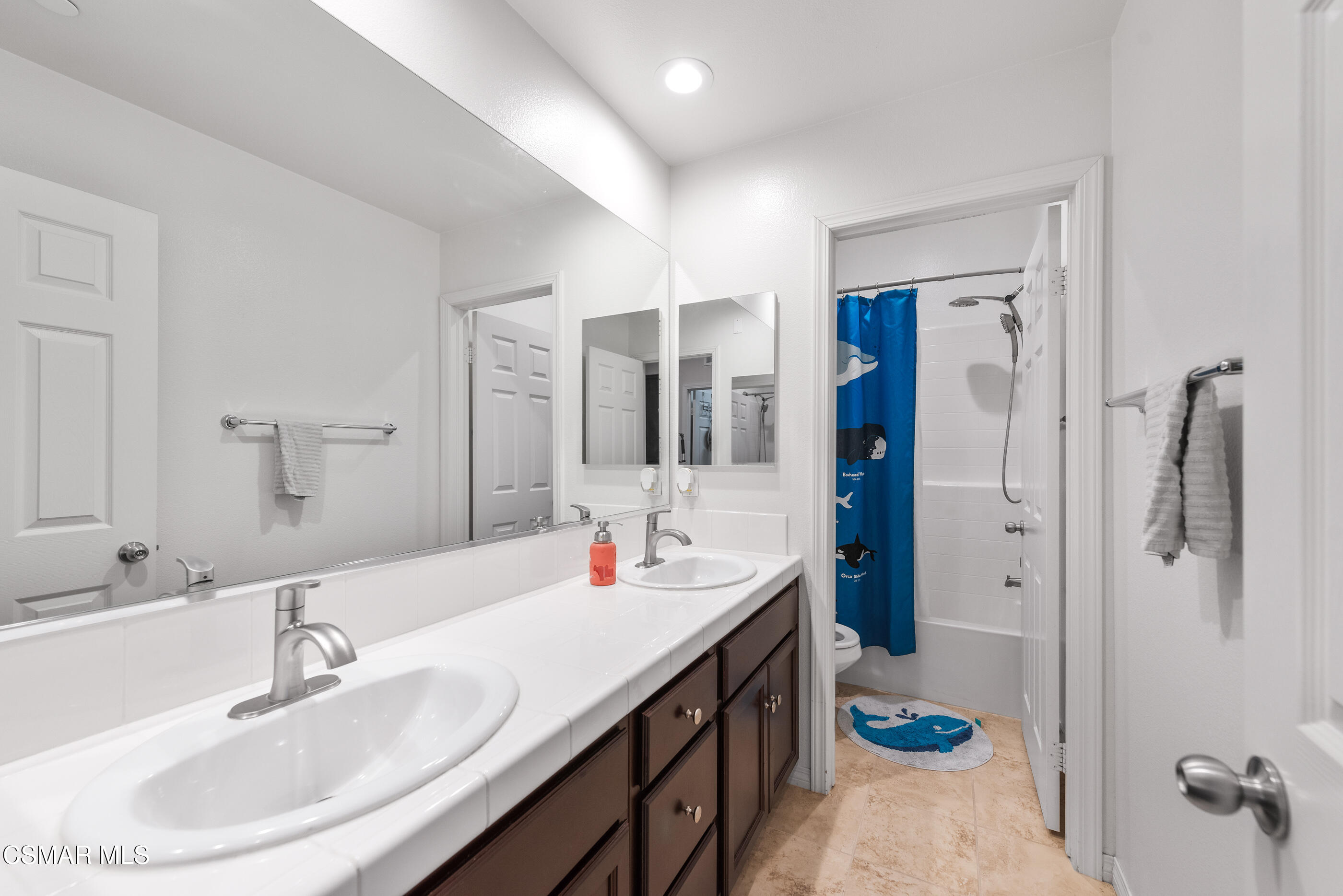 3116 North Oxnard Boulevard Oxnard, CA 93036 - Photo 24 of 46 a bathroom with a double vanity sink a mirror and shower
