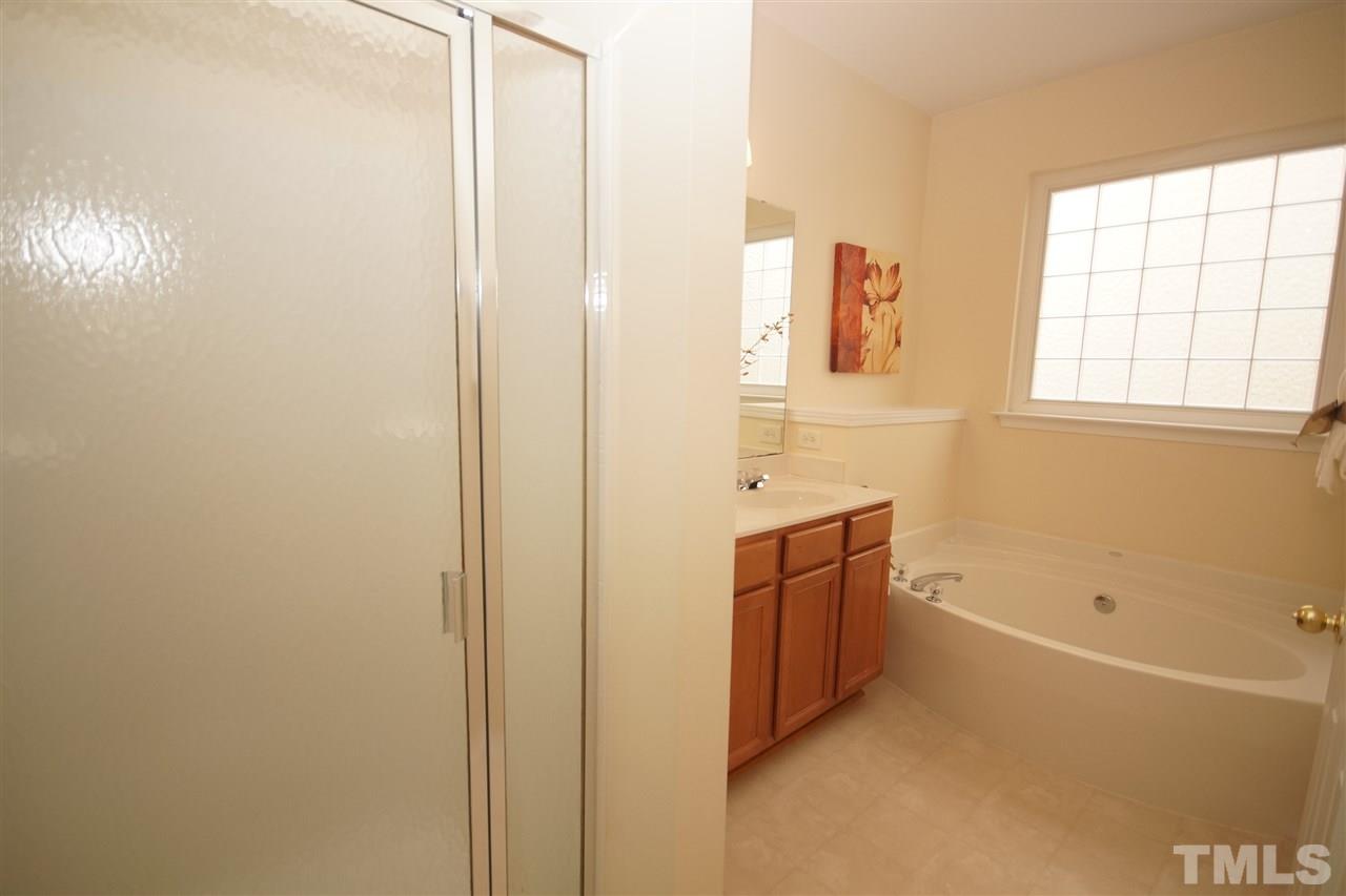 8429 Header Stone Drive Raleigh, NC 27613 - Photo 13 of 19 a bathroom with a tub sink and mirror