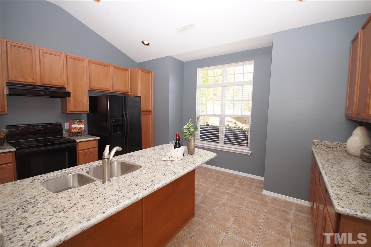 8429 Header Stone Drive Raleigh, NC 27613 - Photo 7 of 19 a kitchen with stainless steel appliances granite countertop a sink refrigerator and microwave