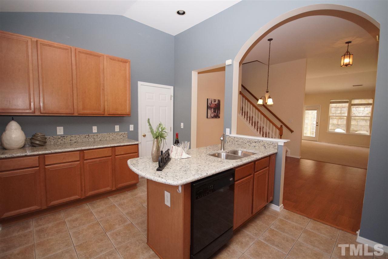 8429 Header Stone Drive Raleigh, NC 27613 - Photo 9 of 19 a kitchen with a sink and cabinets
