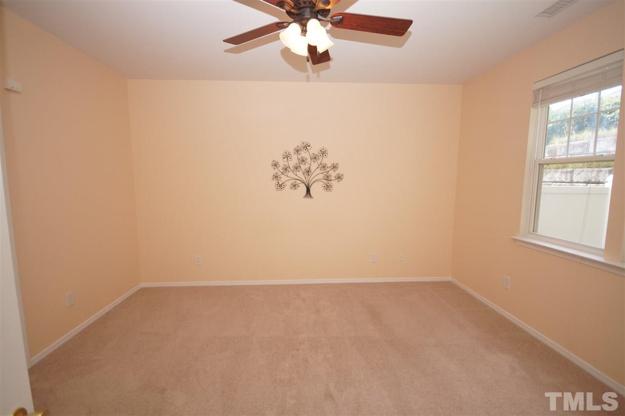 8429 Header Stone Drive Raleigh, NC 27613 - Photo 10 of 19 an empty room with a window and a fan