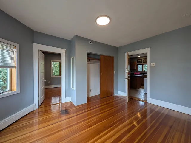 a view of a room with wooden floor and a sink