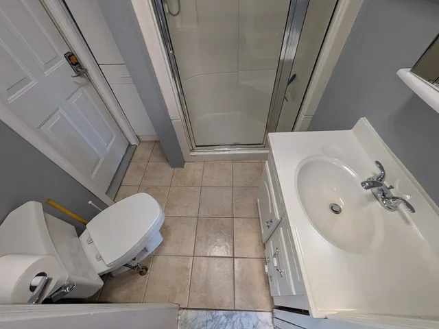 a wooden bench sitting in front of a building