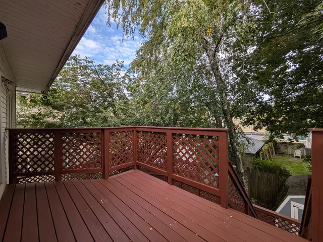 a view of wooden deck with a large window
