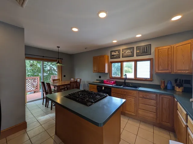 a kitchen with a stove a sink a microwave and a counter