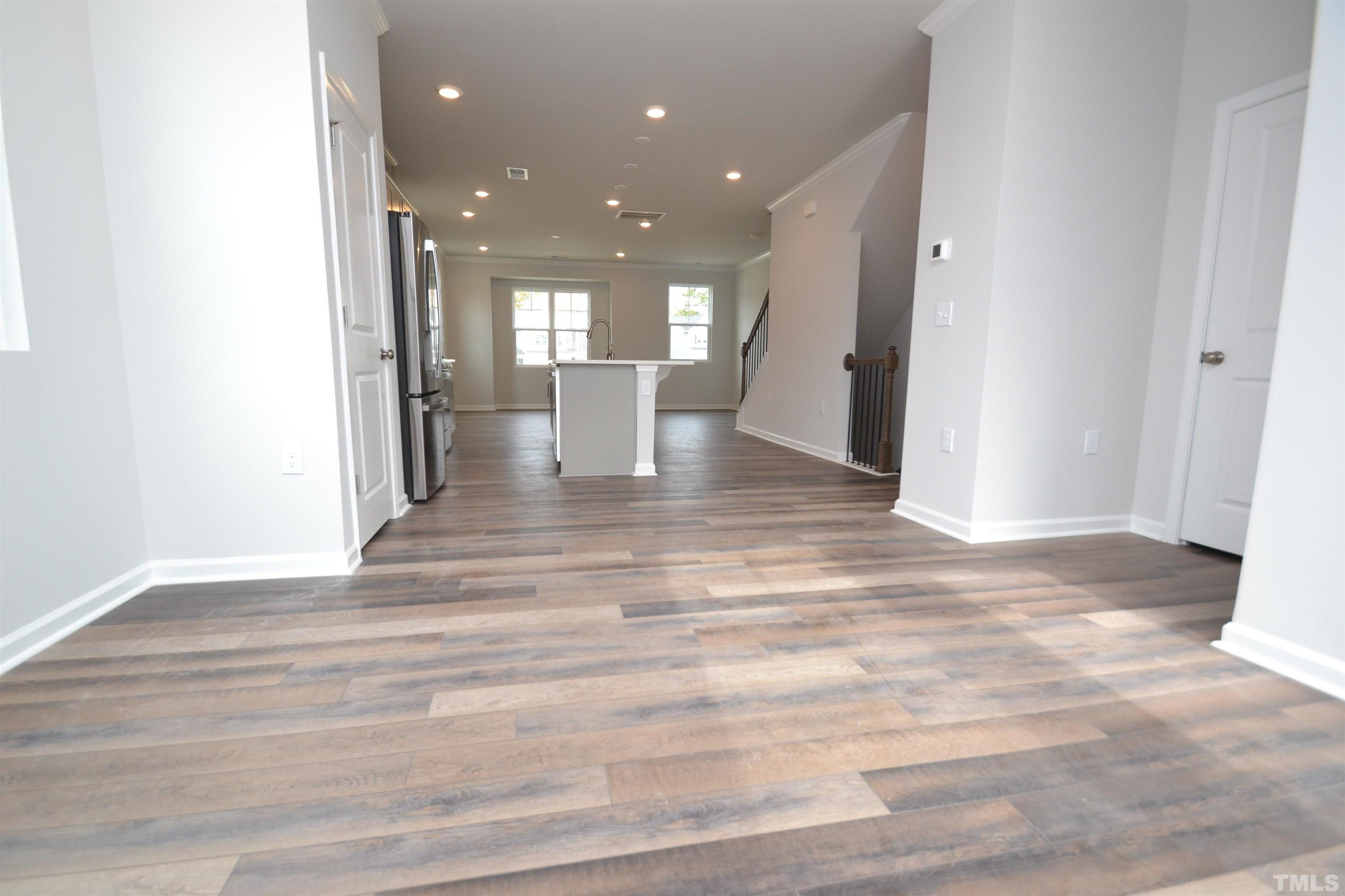1837 Joscara Lane Apex, NC 27502 - Photo 14 of 45 a view of a hallway with wooden floor