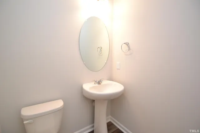 a bathroom with a sink a mirror and a toilet
