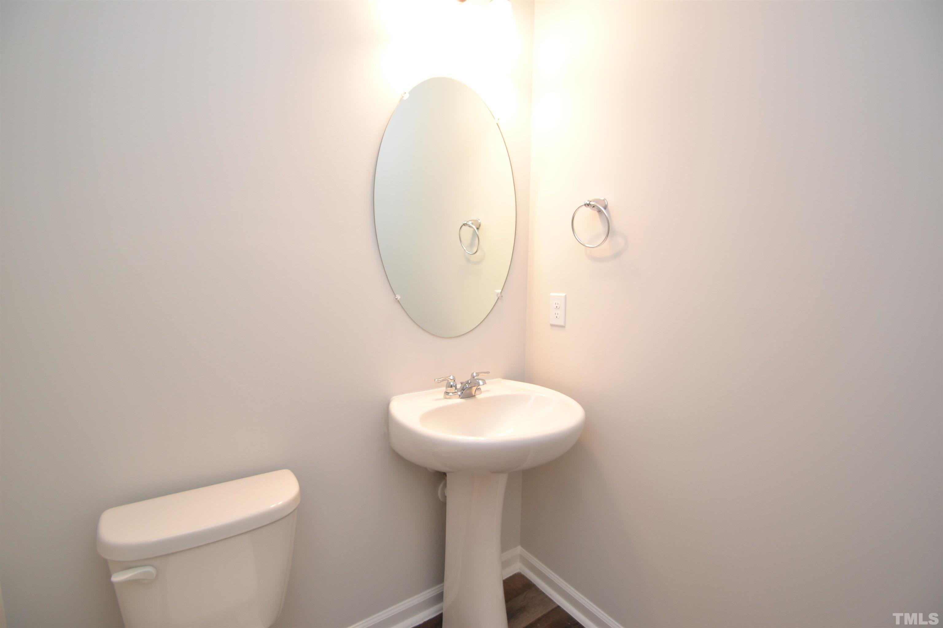 1837 Joscara Lane Apex, NC 27502 - Photo 15 of 45 a bathroom with a sink a mirror and a toilet
