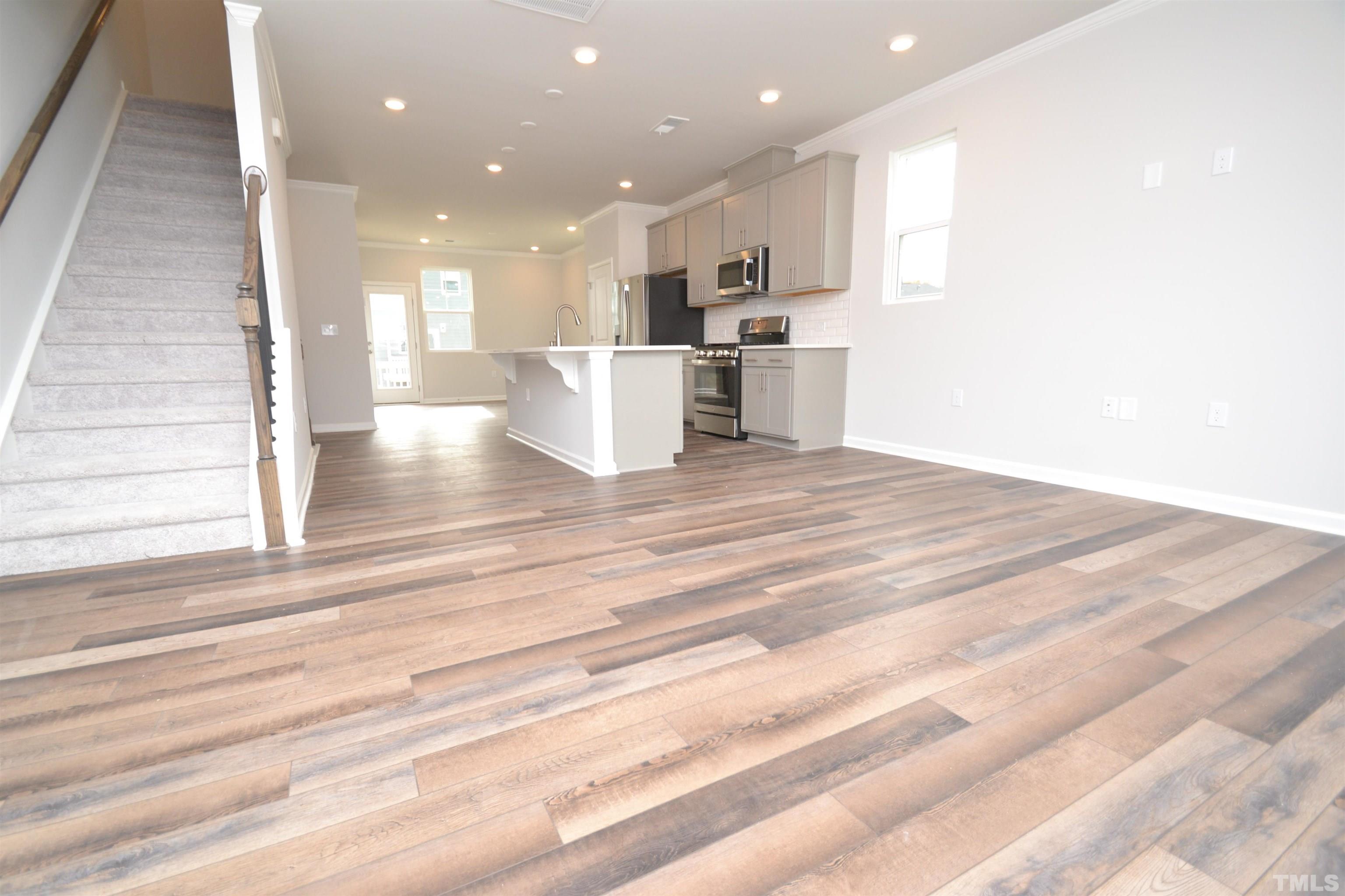 1837 Joscara Lane Apex, NC 27502 - Photo 20 of 45 a view of kitchen with kitchen island microwave and refrigerator