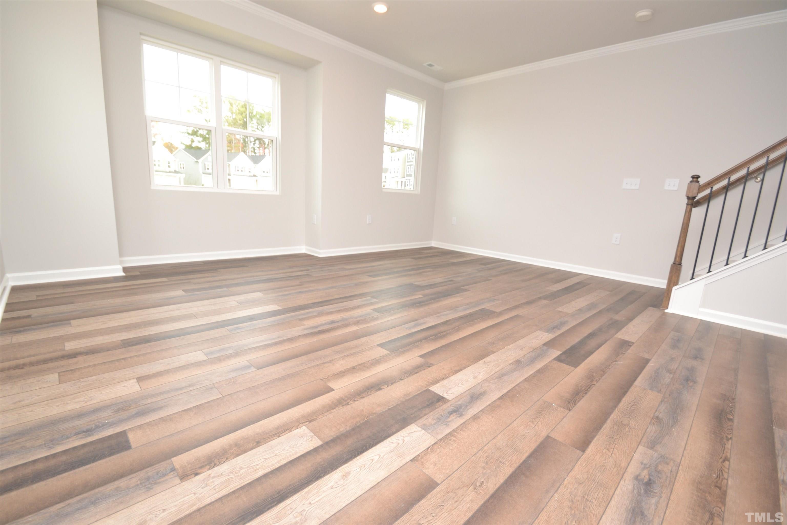 1837 Joscara Lane Apex, NC 27502 - Photo 21 of 45 an empty room with wooden floor and windows