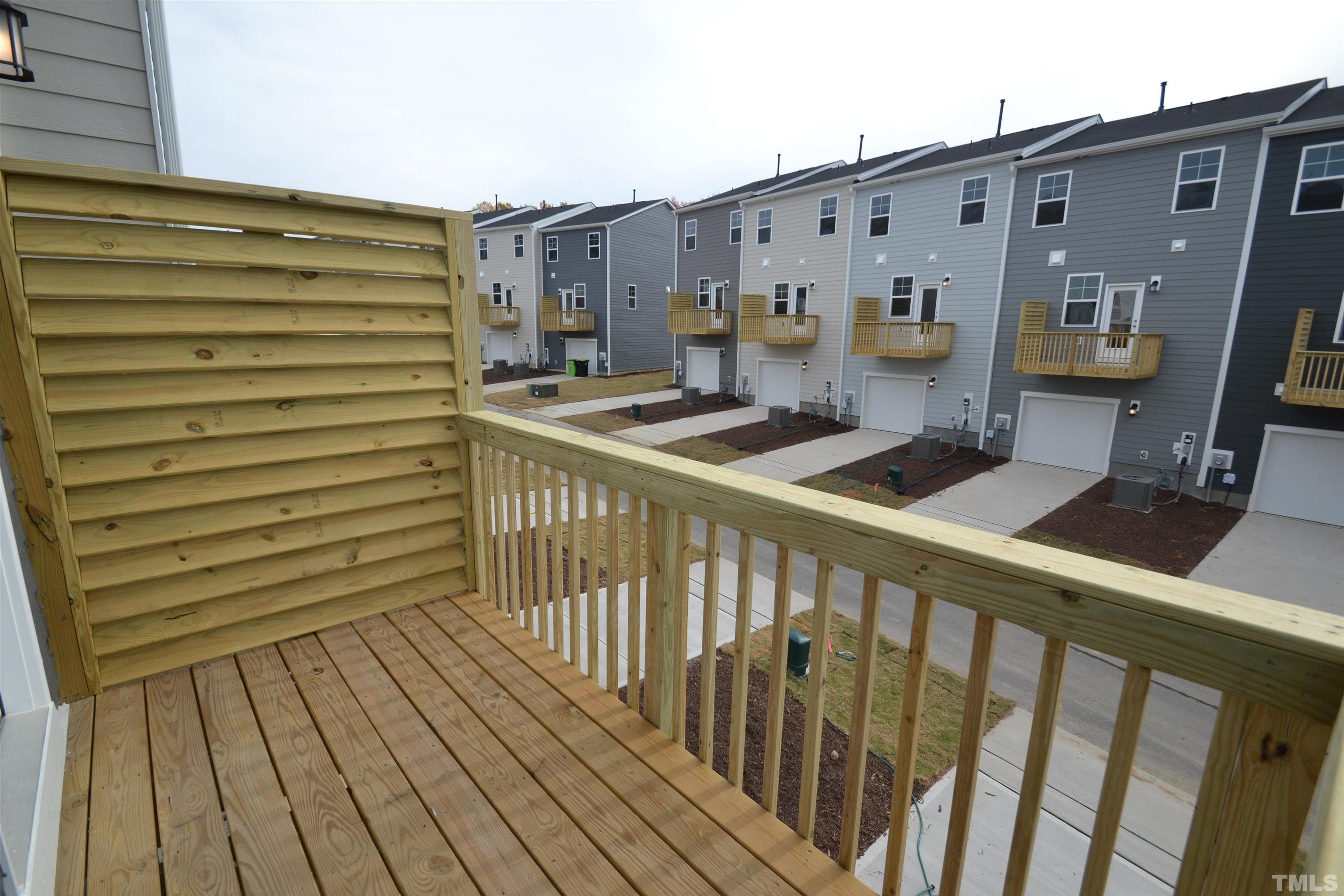 1837 Joscara Lane Apex, NC 27502 - Photo 23 of 45 a view of a balcony with wooden floor and furniture
