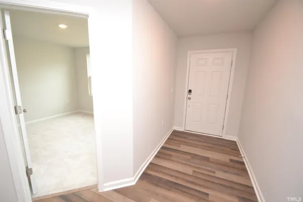 a view of a hallway with wooden floor