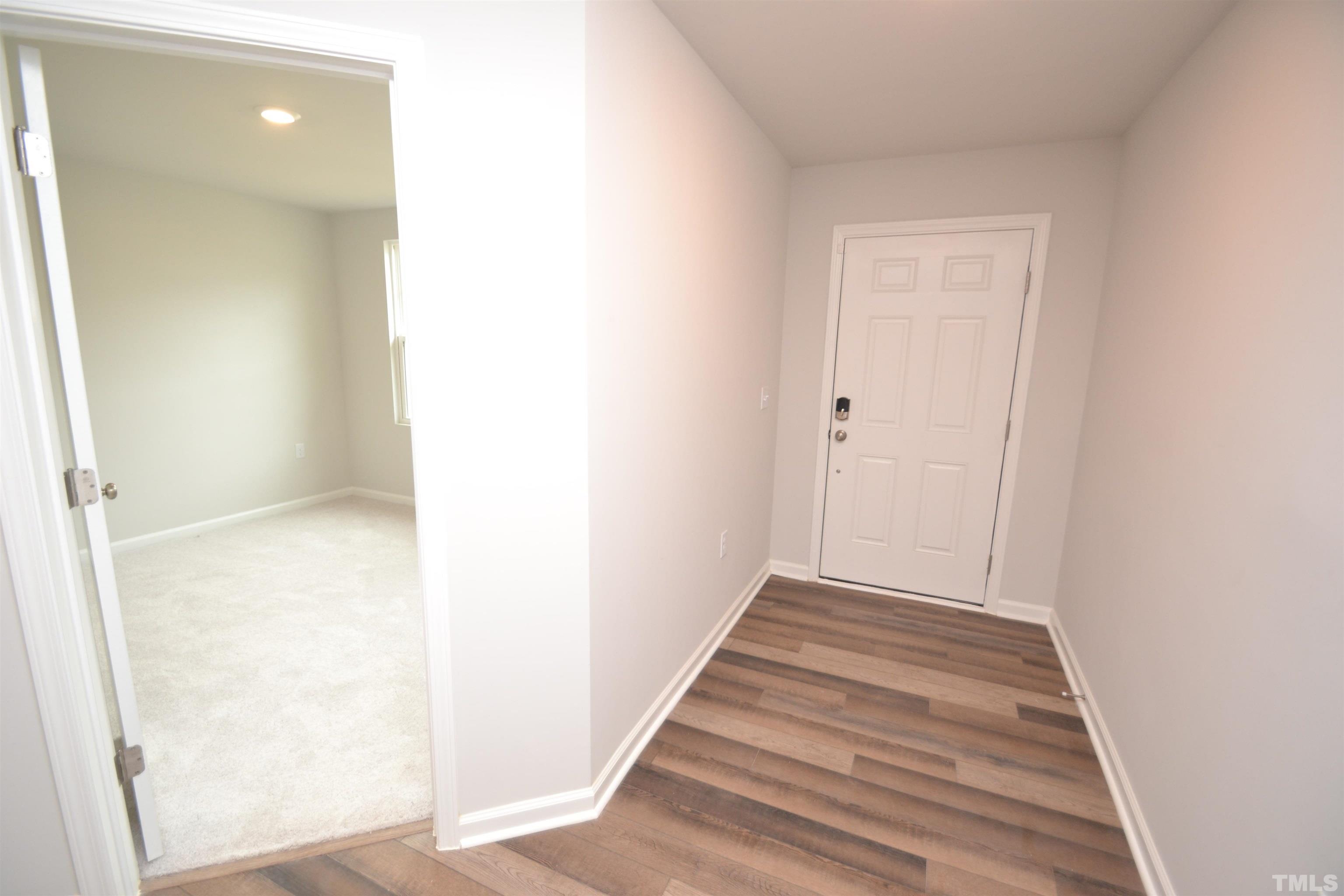 1837 Joscara Lane Apex, NC 27502 - Photo 3 of 45 a view of a hallway with wooden floor
