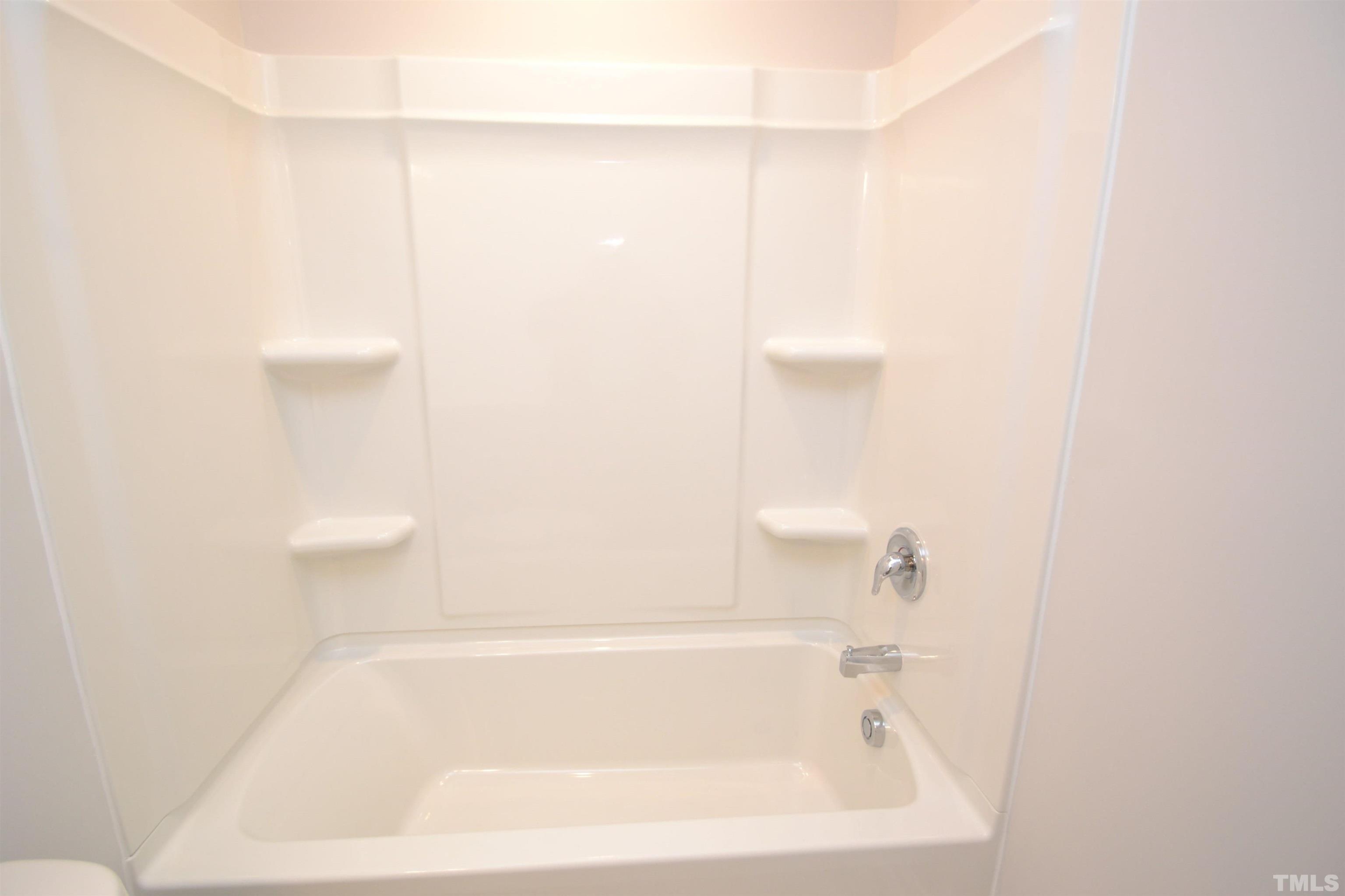 1837 Joscara Lane Apex, NC 27502 - Photo 32 of 45 a bathroom with a bathtub