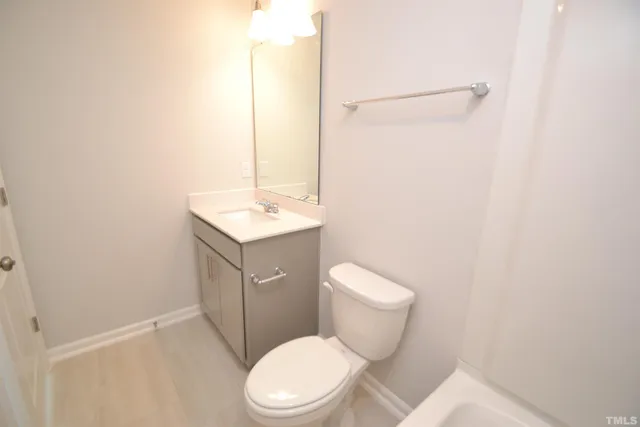 a white toilet sitting next to a bathroom sink