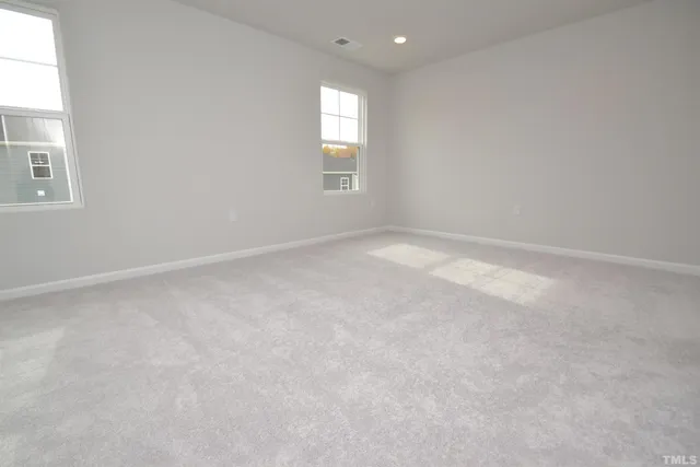 an empty room with windows and closet