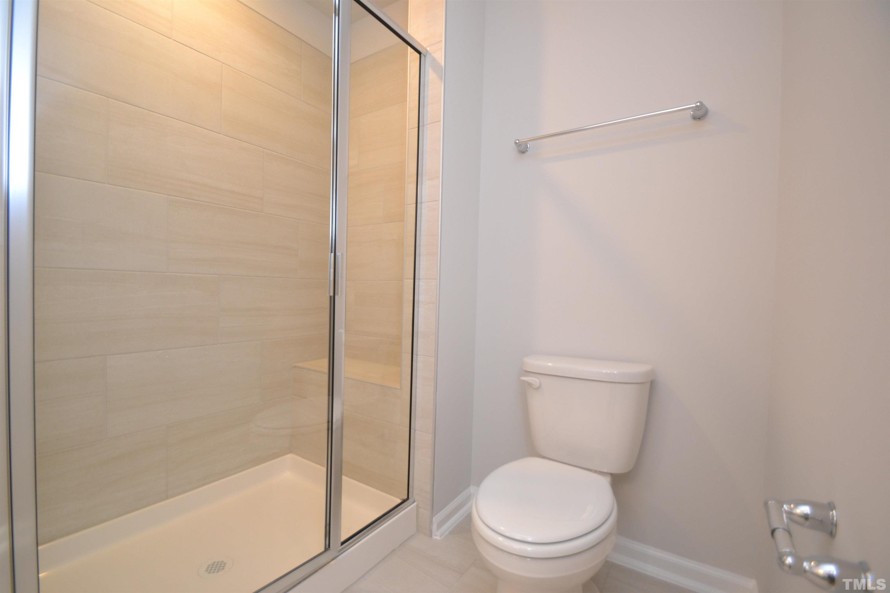 1837 Joscara Lane Apex, NC 27502 - Photo 38 of 45 a white toilet sitting next to a bath tub