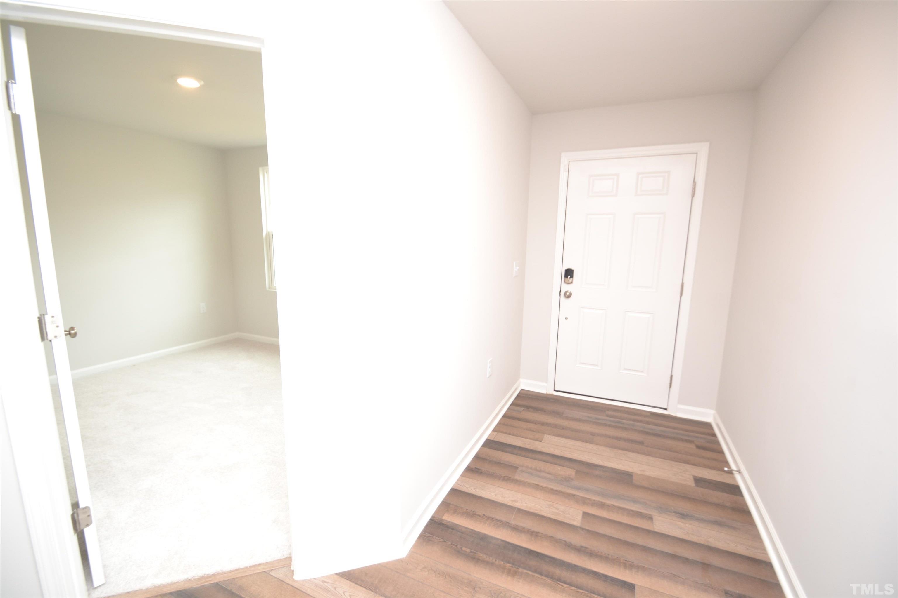 1837 Joscara Lane Apex, NC 27502 - Photo 4 of 45 a view of a hallway with wooden floor