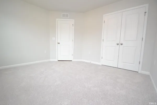 a view of an empty room and entryway