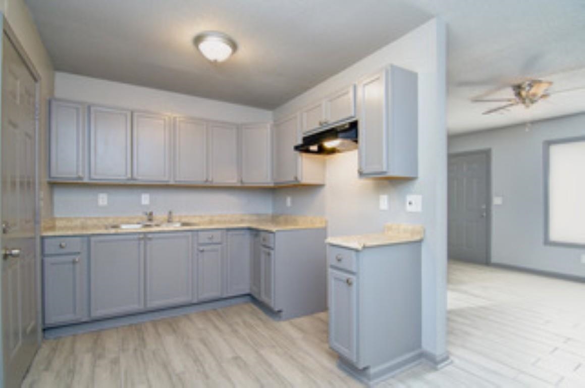 396 West Holmes Road Memphis, TN 38109 - Photo 5 of 12 a kitchen with granite countertop a sink and cabinets