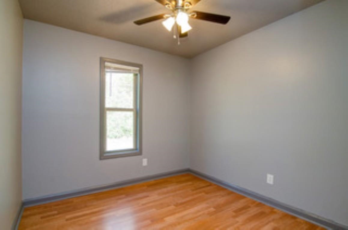 396 West Holmes Road Memphis, TN 38109 - Photo 6 of 12 a view of a big room with windows and chandelier fan