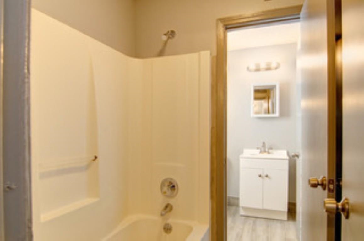 396 West Holmes Road Memphis, TN 38109 - Photo 7 of 12 a bathroom with a bathtub and a shower