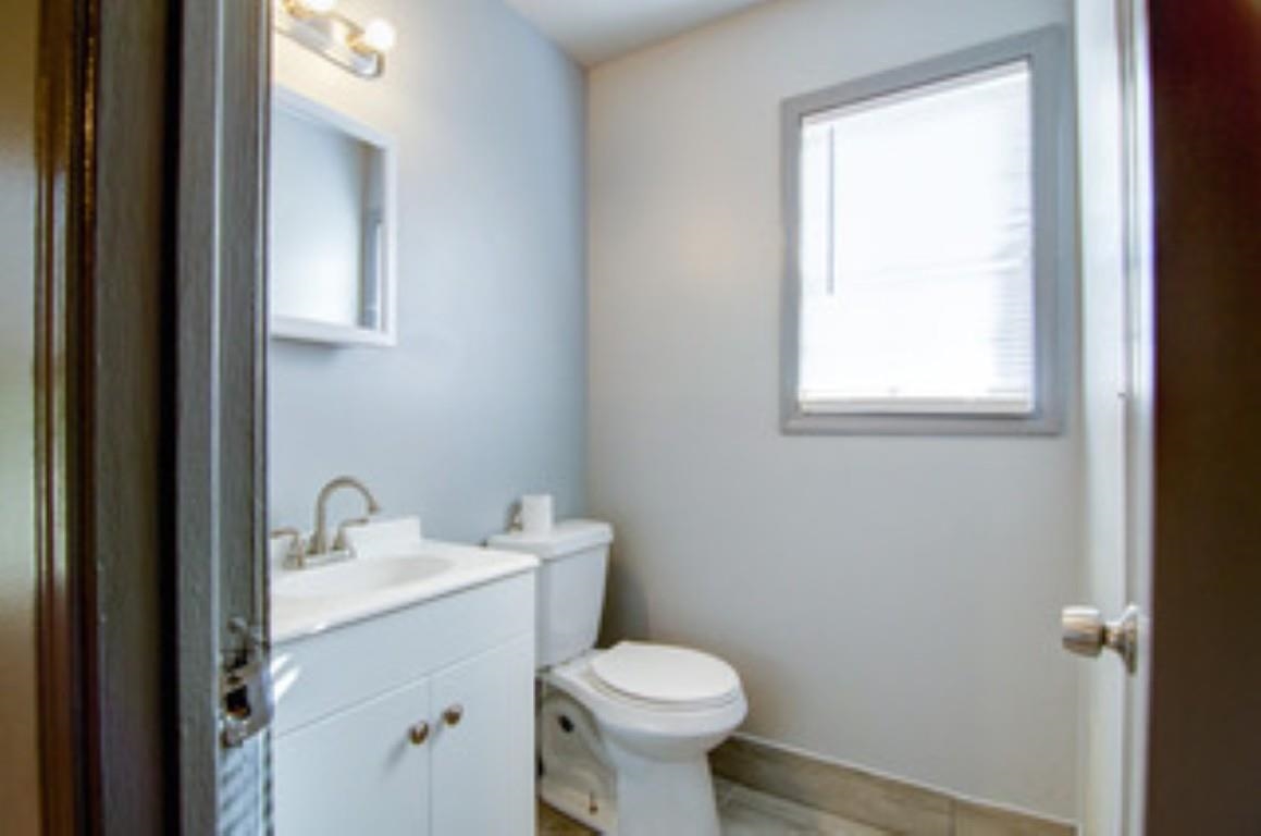 396 West Holmes Road Memphis, TN 38109 - Photo 8 of 12 a bathroom with a sink toilet and a mirror
