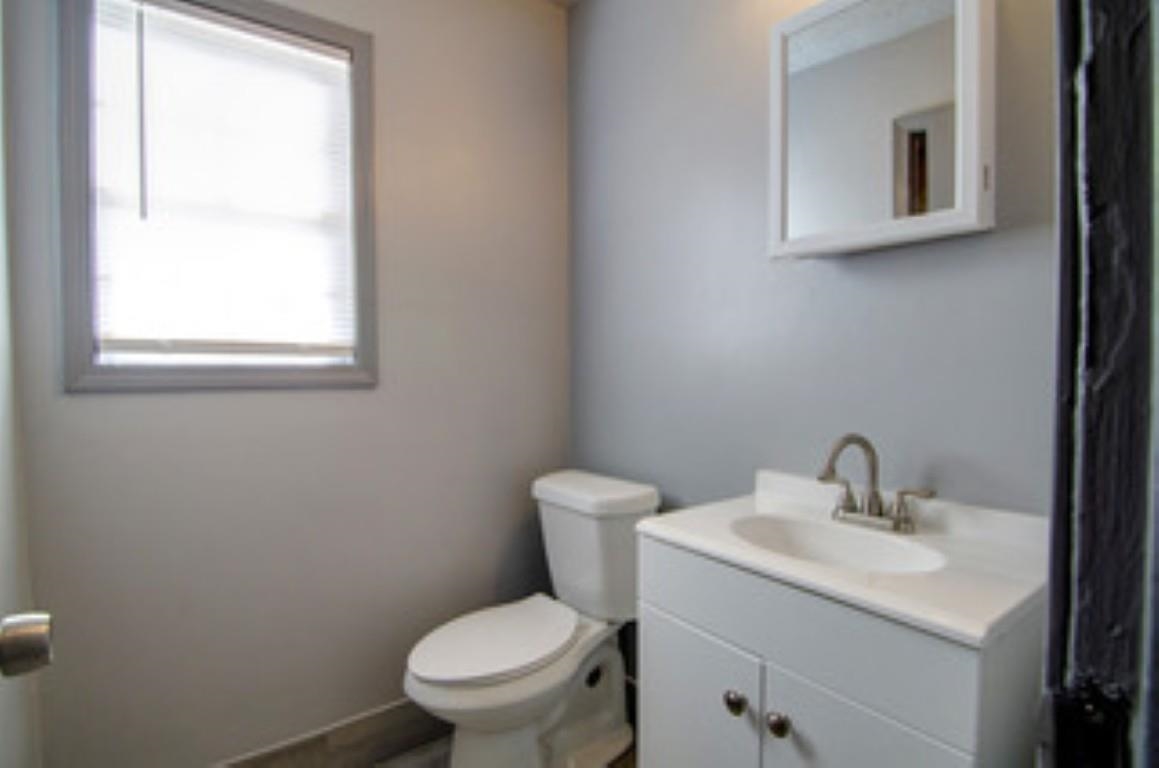 396 West Holmes Road Memphis, TN 38109 - Photo 9 of 12 a bathroom with a toilet sink and mirror
