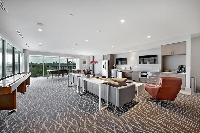 a living room with lots of furniture and kitchen view