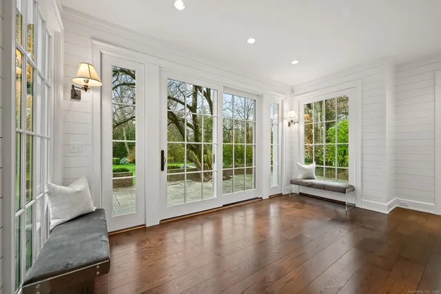 a view of a big room with wooden floor and windows