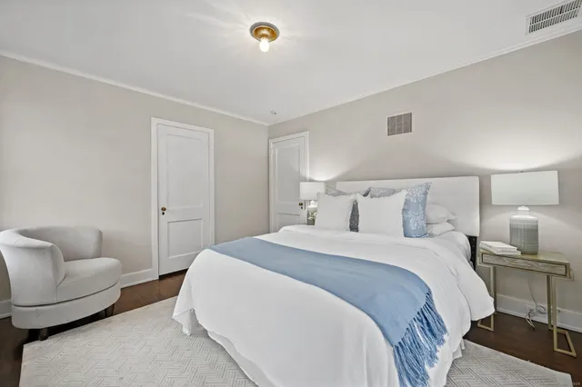 a bathroom with a sink a toilet a mirror and shower