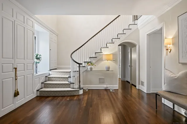 a view of entryway with wooden floor and stairs