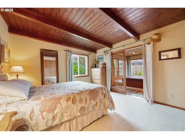 a spacious bedroom with a large bed and wooden floor