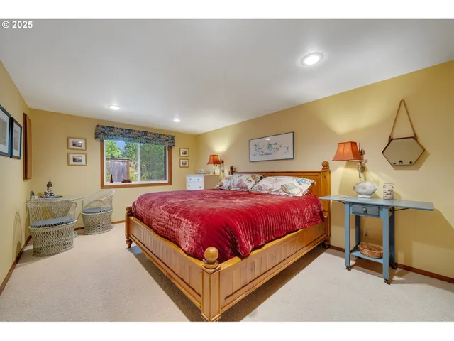 a spacious bedroom with a bed and window