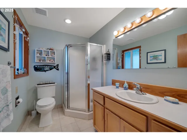 a bathroom with a sink a toilet and a large mirror