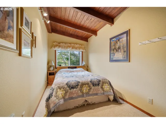 a bed sitting in a bedroom next to a window