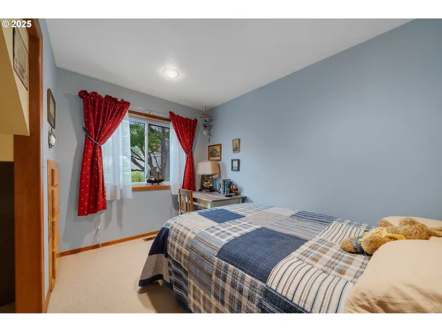 a bedroom with a bed and a large mirror