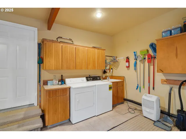 a utility room with sink dryer and washer
