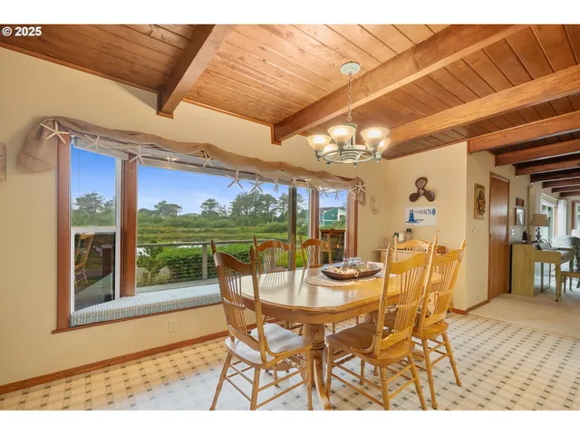 a dining room with furniture a chandelier and wooden floor