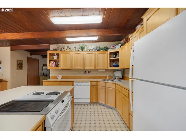 a kitchen with kitchen island a sink stove and cabinets