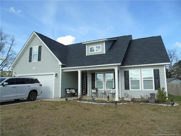 a front view of a house with parking space