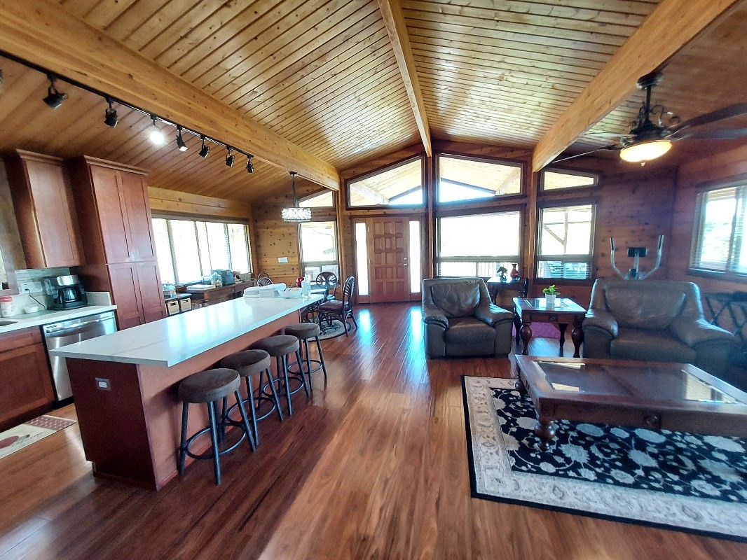 533 Hoaka Road Hilo, HI 96720 - Photo 4 of 30 a living room with furniture floor to ceiling window and wooden floor