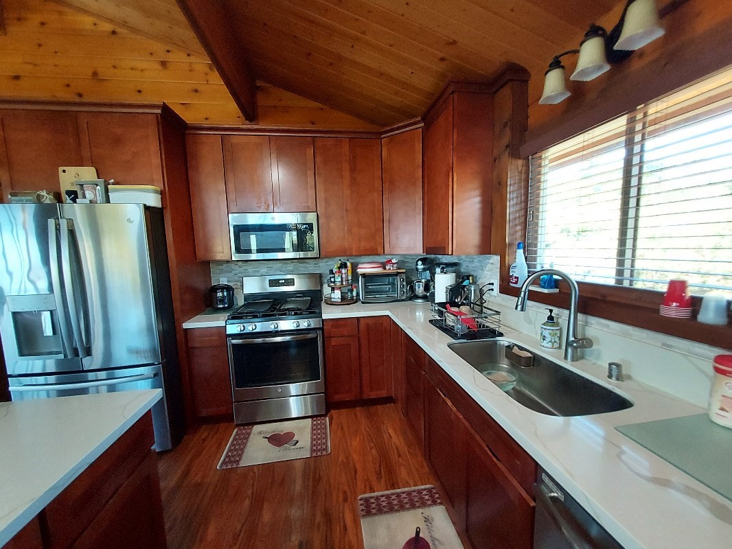 533 Hoaka Road Hilo, HI 96720 - Photo 8 of 30 a kitchen with stainless steel appliances granite countertop a sink a stove and a refrigerator