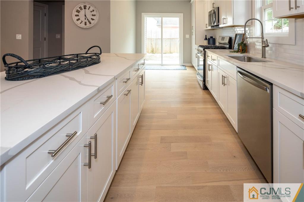 37 Markham Road Edison, NJ 08817 - Photo 6 of 30 a large kitchen with a sink and cabinets